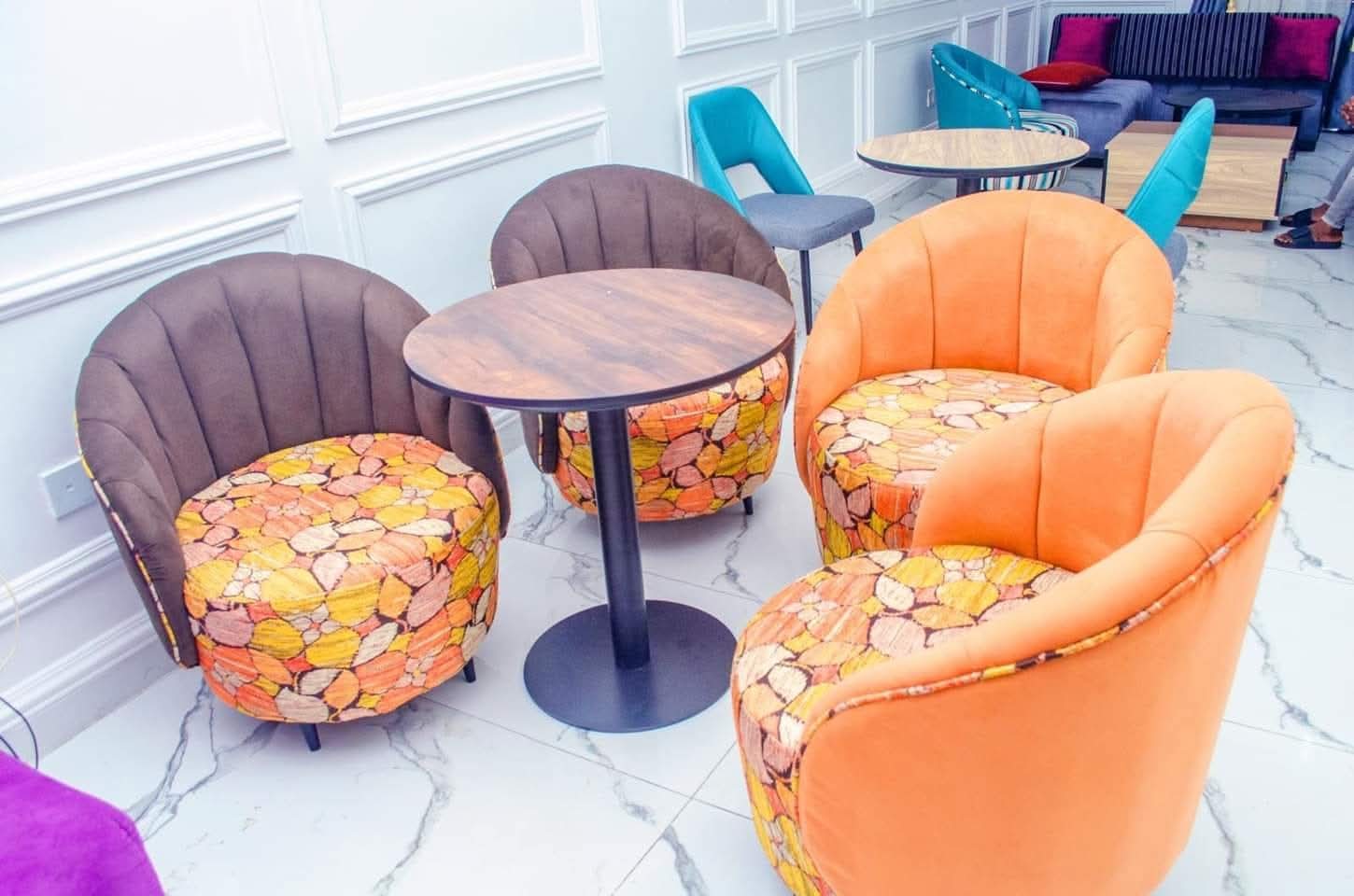 Down lounge seating with armchairs and tables at SOCHIEE Hotel Asaba